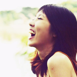 A woman laughing and smiling outside