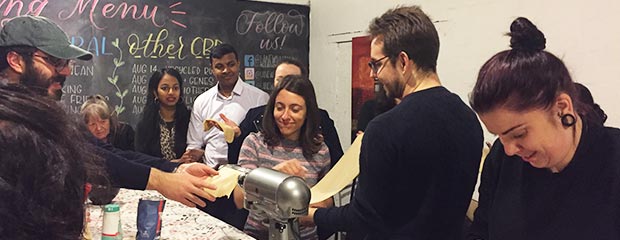 A group making pasta from scratch.